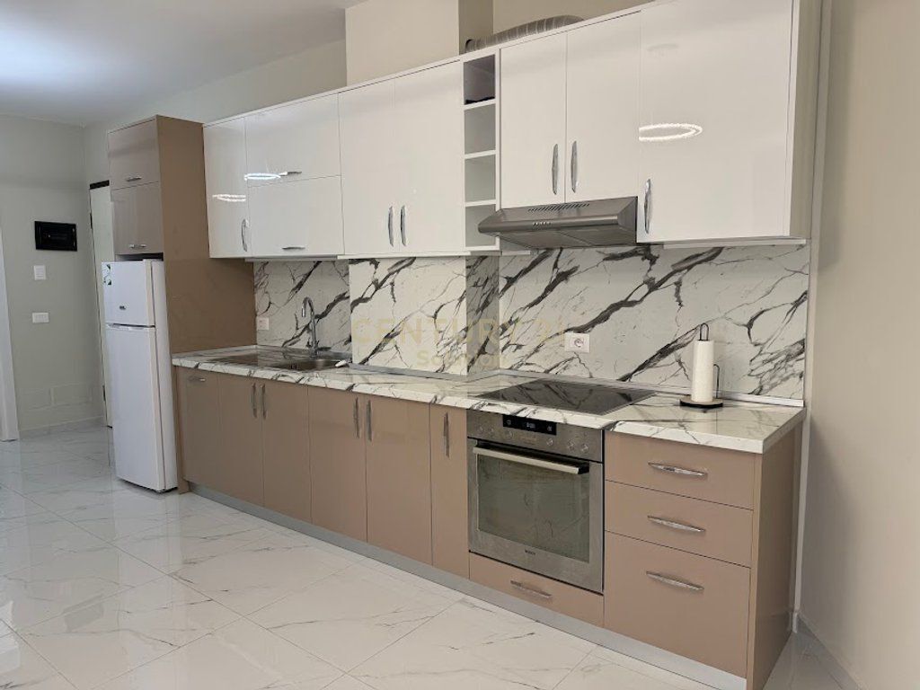 Apartment 2+1 for rent in the Golden Tower residence, on Mine Peza Street. The apartment is located on the 7th floor and offers a functional layout with spacious rooms and natural lighting. The property has a total area of 105 m² (87 m² net) and has never been inhabited before, offering completely new living conditions. The residence is modern, with management and high construction standards, in one of the most sought-after areas of Tirana. Price: 1,300 €/month For more information or a property visit, contact.